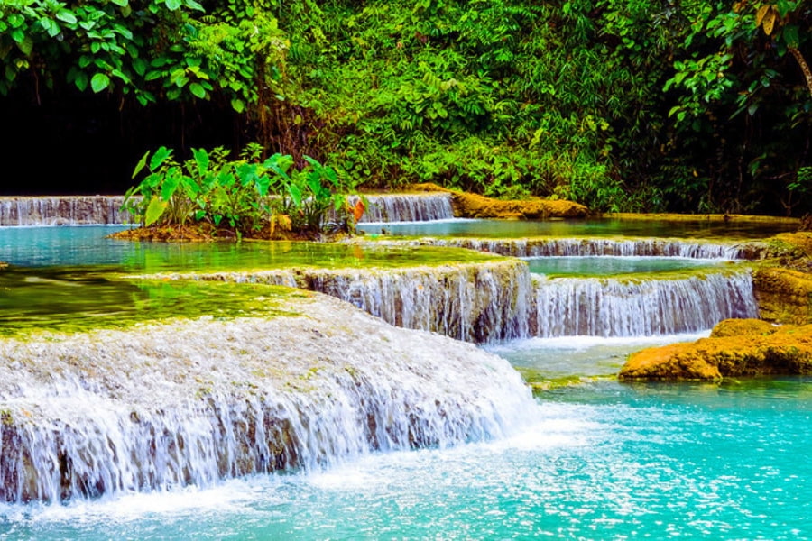 Turquoise Kuang Si Waterfall cascading into natural pools in Laos
